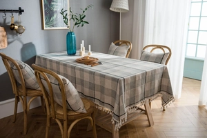 Detail showing grey plaid cotton linen tablecloth with elegant white fringe tassels