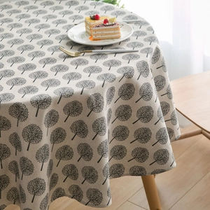 Close-up of cotton linen round tablecloth with black tree print in Nordic minimalist style