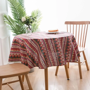 Close-up of Bohemian geometric diamond pattern on round linen blend tablecloth fabric
