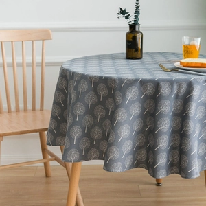 Nordic grey cotton linen round tablecloth with white tree print on a dining table