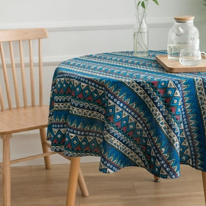 Detailed view of bohemian blue geometric print round tablecloth in a cozy home setting