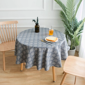 Detail of Nordic style round cotton linen tablecloth with black tree print patterns