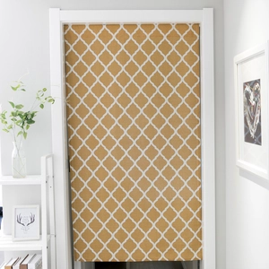 Detail of ochre geometric trellis pattern door curtain on a thick linen fabric