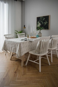 Detail of modern black and white geometric grid tablecloth with matching chair cushions
