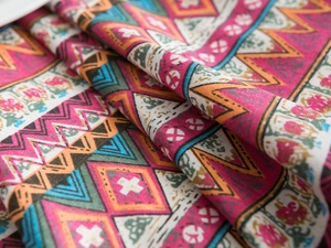Macro view of geometric ethnic patterns on thick cotton linen tablecloth fabric