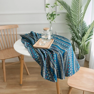 Bohemian style blue geometric pattern linen tablecloth draped over a round dining table