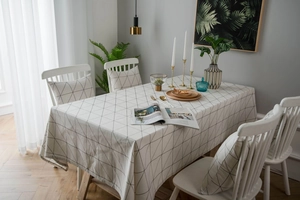 Detail of minimalist black and white geometric tablecloth with matching chair covers set