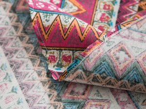 Close-up of geometric ethnic print tablecloth showing fabric texture and edge stitching