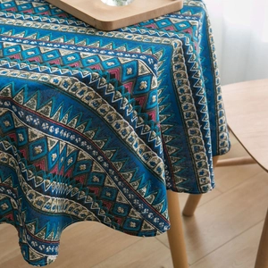 Bohemian blue geometric print tablecloth in linen fabric on a wooden dining table