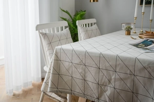 Detail of minimalist geometric cotton linen tablecloth with black triangle grid pattern