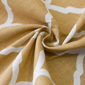 Detailed macro view of yellow geometric cotton linen fabric with crisp printed patterns