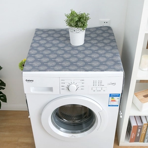 Grey washing machine dust cover with white tree patterns and decorative plush pom-poms