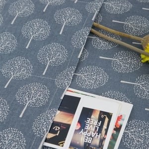 Close-up of grey linen refrigerator cover fabric with white tree print and side pockets