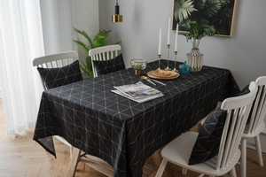 Detailed view of black and white geometric cotton linen tablecloth and matching cushions