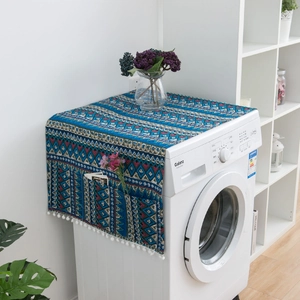 Detail view of Bohemian blue geometric washing machine cover with side pockets and tassels