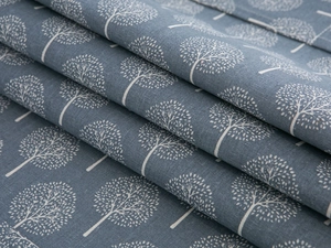 Macro detail of thick grey-blue cotton linen fabric with white tree patterns