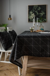 Detailed close-up of modern black and white geometric table runner in linen fabric