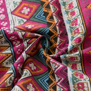 Close-up of bohemian geometric patterns and woven texture on red partition door curtain