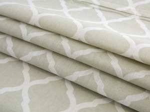 Macro detail of geometric Moroccan lattice fabric showing thick cotton linen texture