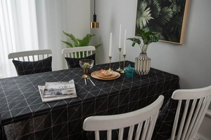 Detailed view of black cotton linen tablecloth with white geometric grid pattern