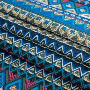 Detailed macro view of bohemian geometric pattern fabric with deep blue ethnic prints