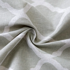 Macro detail of light green geometric print fabric with natural cotton linen texture