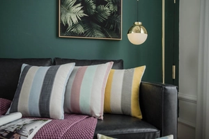 Detail of three striped decorative pillows with blue, pink, and yellow woven textures