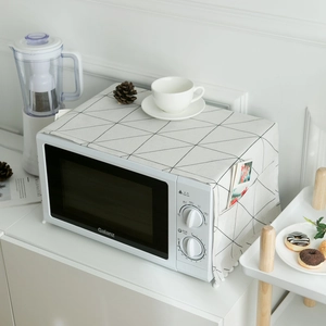 Detail of Nordic dust cover with black geometric patterns, white tassels and storage pockets