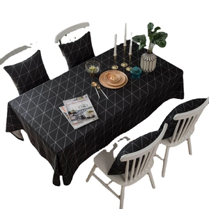 Modern black and white geometric grid tablecloth set with matching chair cushion covers