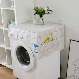 Detail of geometric pattern dust cover with storage pockets and white tassel trim