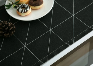 Close-up of geometric dust cover fabric showing heavy texture and black-white pattern