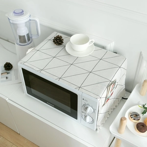 Nordic black and white dust cover for microwave with storage pockets and pompom trim