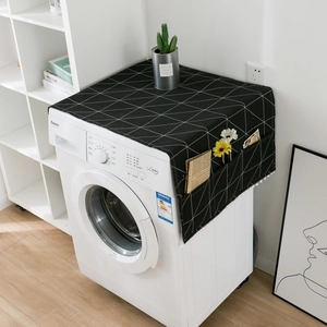 Minimalist black geometric fridge cover with storage pockets and white tassel trim