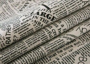 Detail of linen fabric with vintage newspaper print and industrial design texture