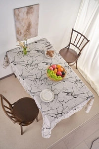 Close-up detail of white marble pattern tablecloth on a rectangular dining table