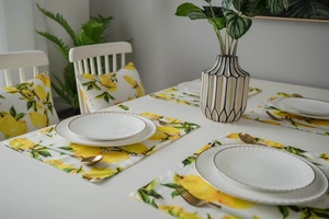 Detailed view of lemon print table mat and matching cushion for fresh kitchen decor