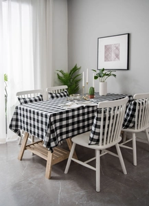 Detailed view of black and white checkered tablecloth and matching chair cushion fabric