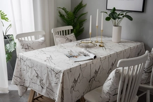 Macro detail of Nordic marble print tablecloth with matching cushion cover in cotton linen