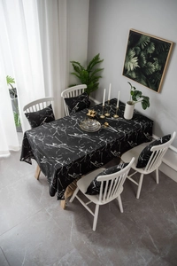 Detailed overhead view of modern black marble print tablecloth with matching seat cushions