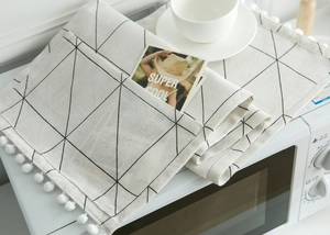 Detail of Nordic appliance cover with black geometric patterns and side pockets