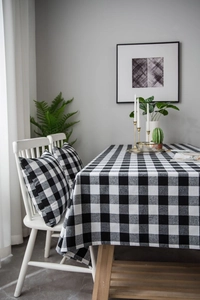 Detailed texture of black and white buffalo check cotton linen tablecloth and matching cushion