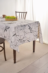 Close-up of modern white marble pattern linen tablecloth on a wooden dining table