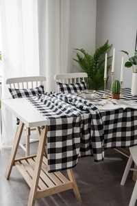 Macro detail of high-quality black and white gingham tablecloth with matching cushions