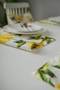 Close-up of lemon print place mat and matching cushion on high-quality linen fabric