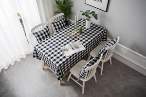Detail of buffalo check tablecloth and matching chair pads in modern farmhouse style