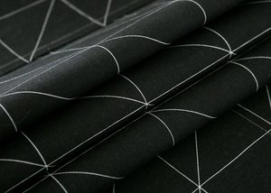 Macro shot of durable black fabric with white geometric patterns and woven texture