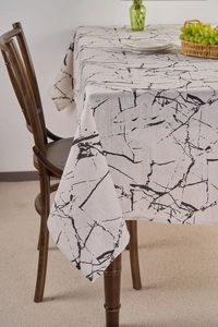 Detail of white marble print linen tablecloth with soft drape and natural texture style
