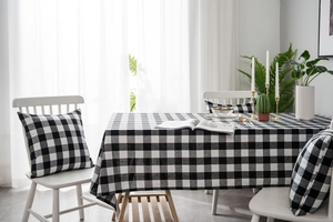 Macro detail of black and white checkered tablecloth and cushion cover in a home setting