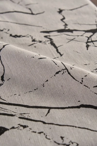 Close-up detail of white marble pattern on premium cotton linen tablecloth fabric