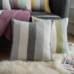 Modern minimalist yarn-dyed striped throw pillow cover on a leather sofa